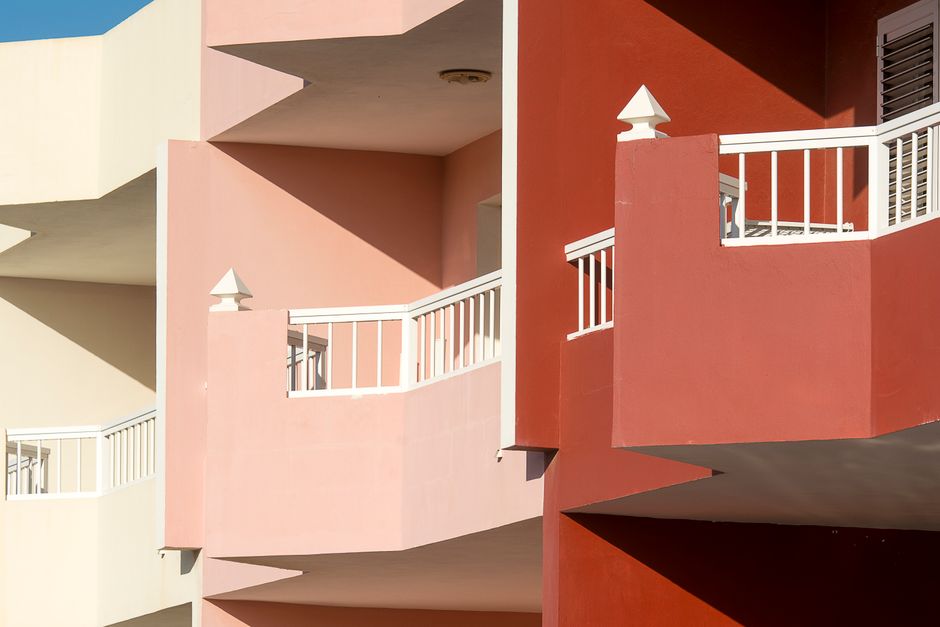 Painted building wall with balconies in bright colours.
